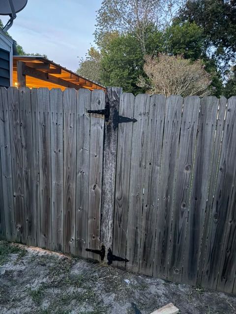 The same gate re-hung on its strap hinges, square in its frame.