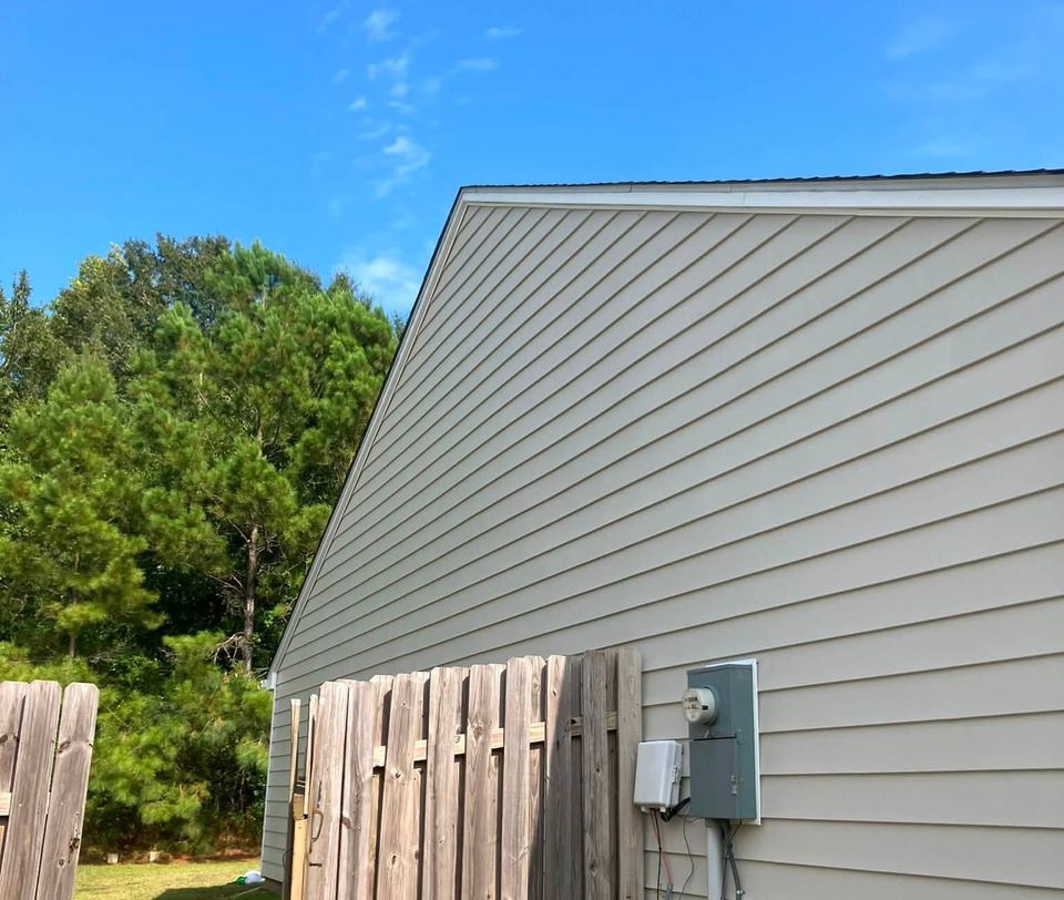 The same siding after a soft wash, back to clean tan vinyl.